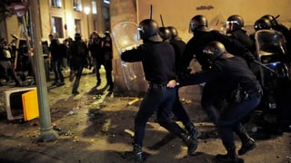 Polizisten und Demonstranten kämpfen gegeneinander.