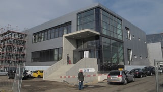 Gebäude von aussen, ein Stahl und Glasbau. Ein Teil davon befindet sich (am linken Bildrand) noch im Bau.