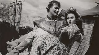 John Wayne trägt Susan Hayward auf Händen. John Wayne trägt Susan Hayward auf Händen.