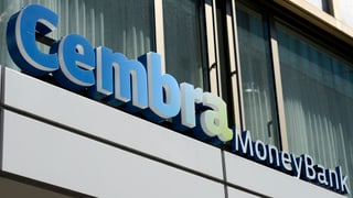 Der Schriftzug der Bank vor zwei Fenstern, eines Bürogebäudes mit Metallfassade Der Schriftzug der Bank vor zwei Fenstern, eines Bürogebäudes mit Metallfassade