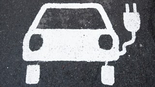 Ein Symbol für ein Elektroauto markiert einen Parkplatz neben einer E-Ladesäule in Deutschland. Ein Symbol für ein Elektroauto markiert einen Parkplatz neben einer E-Ladesäule in Deutschland.