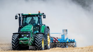 Traktor wirbelt Staub auf Traktor wirbelt Staub auf