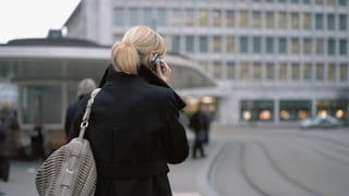 Frau am Handy am Paradeplatz in Zürich