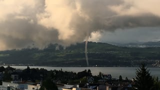 Ein Rüssel reicht von den tiefen Quellwolken bis auf den See hinunter. Ein Rüssel reicht von den tiefen Quellwolken bis auf den See hinunter.
