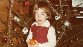Joelle Beeler im Alter von dreieinhalb Jahren vor dem Weihnachtsbaum. Die Fussballkugeln im Baum hat sie erst jetzt entdeckt.
