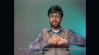 Markus Huser in einer Fernsehaufnahme mit Untertiteln Markus Huser in einer Fernsehaufnahme mit Untertiteln