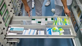 Offener Medikamentenschrank, Schublade nur halbvoll mit Medikamentenpäkchen. Offener Medikamentenschrank, Schublade nur halbvoll mit Medikamentenpäkchen.