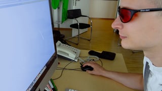 Mann mit Brille schaut in Monitor Mann mit Brille schaut in Monitor
