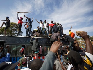 Männer demonstrieren auf einem Bus in Nairobi. 