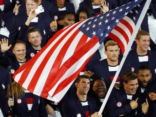 Michael Phelps trägt die US-Flagge ins Stadion.