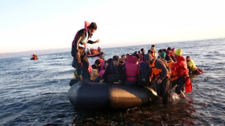 Flüchtlinge bei ihrer Ankunft in einem Schlauchboot auf Lesbos. 