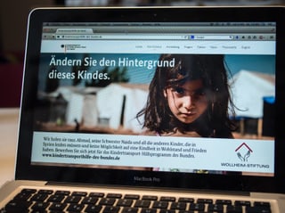 Laptop, auf dem die Website zu sehen ist: Grosses Foto eines KIndes, darüber "Ändern Sie den Hintergrund dieses Kindes". Laptop, auf dem die Website zu sehen ist: Grosses Foto eines KIndes, darüber "Ändern Sie den Hintergrund dieses Kindes".