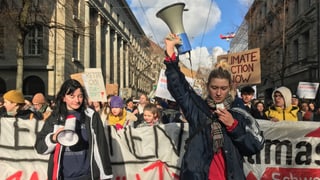 Eine Gruppe Schülerinnen läuft durch Zürich, vorneweg zwei junge Frauen mit einem Megafon in der Hand. Eine Gruppe Schülerinnen läuft durch Zürich, vorneweg zwei junge Frauen mit einem Megafon in der Hand.
