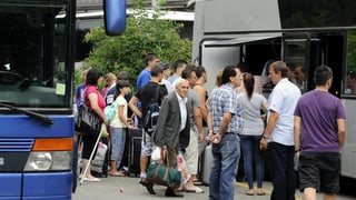 Menschen warten, um in einen Fernbus zu steigen. Menschen warten, um in einen Fernbus zu steigen.