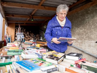 Margrit Bischofberger bestückt den Bücherwagen. Hier können Leute Bücher für einen Franken erstehen.
