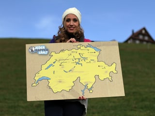 Florence Fischer hält ein Schild mit einer Schweizerkarte