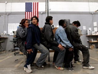 Illegale Einwanderer aus Mexiko warten auf ihre Vernehmung auf einem US-Grenzposten.
