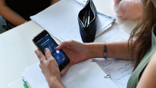 Ein Mädchen gibt ihren Handy-Code ein. Ein Mädchen gibt ihren Handy-Code ein.