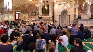 Besucher der Biennale auf dem Gebetsteppich einer alten Kirche, die zu einer Moschee umfunktioniert wurde.