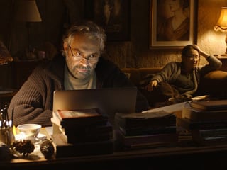 Hauptfigur Aydin in der Schreibstube mit seiner garstigen Schwester Necla im Hintergrund.