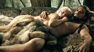 Arm in Arm: Eine Mann und eine Frau liegen nackt im Bett.