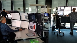 Zwei Arbeitsplätze mit je sechs Monitoren. Zwei Arbeitsplätze mit je sechs Monitoren.