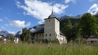 Blick auf das Schloss Wildenberg. Im Hintergrund Bergen und blauer Himmer.