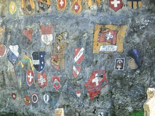 Man sieht eine Felswand mit verschiedenen Schweizer Kantonswappen. Die Wand ist im Chessiloch bei Grellingen. Man sieht eine Felswand mit verschiedenen Schweizer Kantonswappen. Die Wand ist im Chessiloch bei Grellingen.