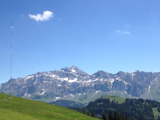 Das Bild zeigt blauen Himmel mit einer kleinen Quellwollke. Im Hintergrund der Alpstein mit Säntis.