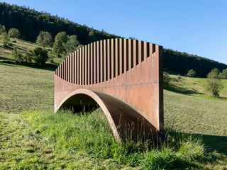 Eine Skulptur steht mitten in der Landschaft.