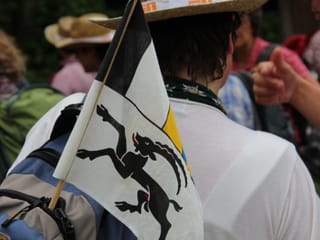 Eine kleine Fahne mit dem Kantonswappen von Graubünden wird im Rucksack mitgeführt.