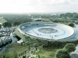 Luftaufnahme eines futuristisch anmutenden runden Platzes inmitteln einer grünen Landschaft.