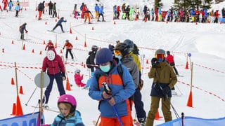 Skifahrer beim Anstehen vor einem Skilift.