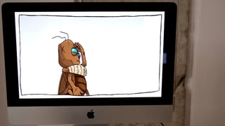 Eine Cartoon-Spielfigur auf einem Macbook.
