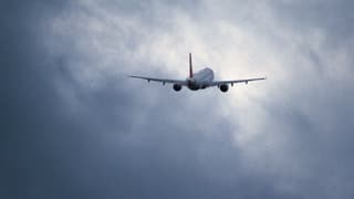 Ein Passagierflugzeug startet in den bedeckten Himmel.