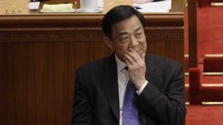 Bo Xilai im Gerichtssaal. Er hält sich die Hand vor den Mund.