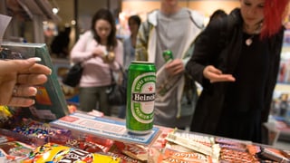 Eine Jugendliche kauft Bier am Kiosk