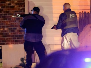 Polizisten zücken die Waffe