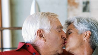 Ein älteres Paar küsst sich