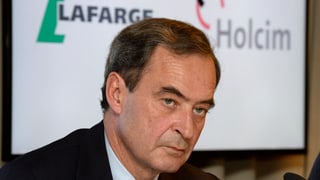 Lafarge-Chef Bruno Lafont an einer Medienkonferenz, im Hintergrund die Logos der beiden Konzerne