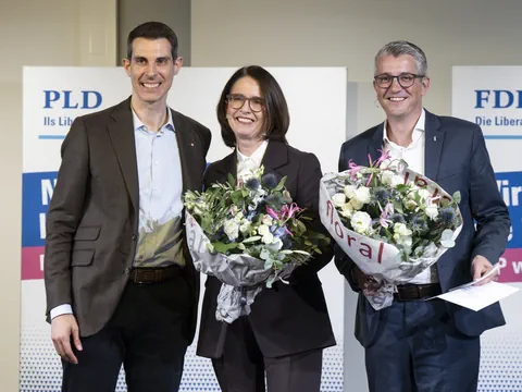 Zwei Männer und eine Frau. Zwei davon mit Blumenstrauss.