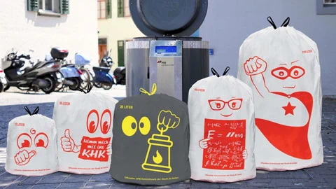 Bunte Müllsäcke mit Cartoon-Aufdrucken auf dem Gehweg.