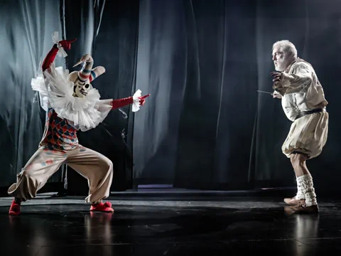 Zwei Schauspieler in historischen Kostümen auf der Bühne.