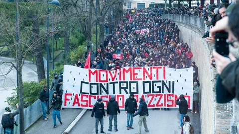 Ein Demonstrationszug hinter einem Transparent mit der Aufschrift: «Bewegung gegen jegliche Art von Faschismus und Rassismus».