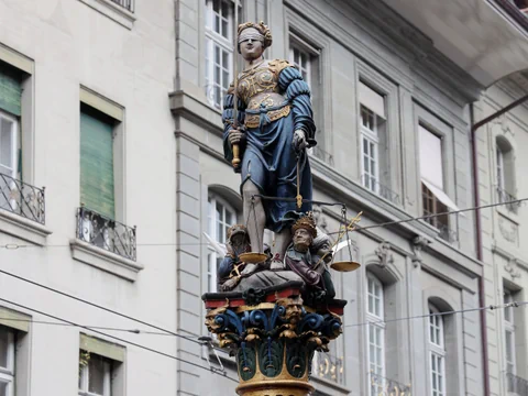 Justizia-Brunnen vor Häuserfront