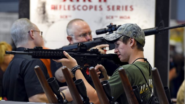 Männer probieren Waffen aus. Männer probieren Waffen aus.