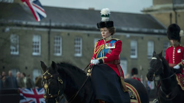 Eine Frau sitzt in Uniform auf einem Pferd. Eine Frau sitzt in Uniform auf einem Pferd.