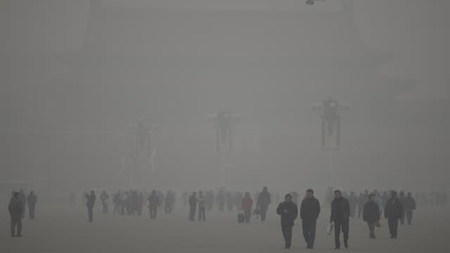 Chinesische Passanten gehen im Smog. Chinesische Passanten gehen im Smog.