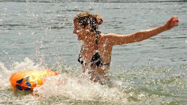 Eine Frau springt in Rhein bei Basel. Das Wasser spritzt. Eine Frau springt in Rhein bei Basel. Das Wasser spritzt.