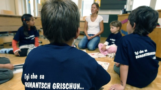 Kinder im Kindergarten mit blauen T-Shirts.